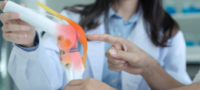 A doctor holding a model of a broken arm, demonstrating the injury for educational purposes.
