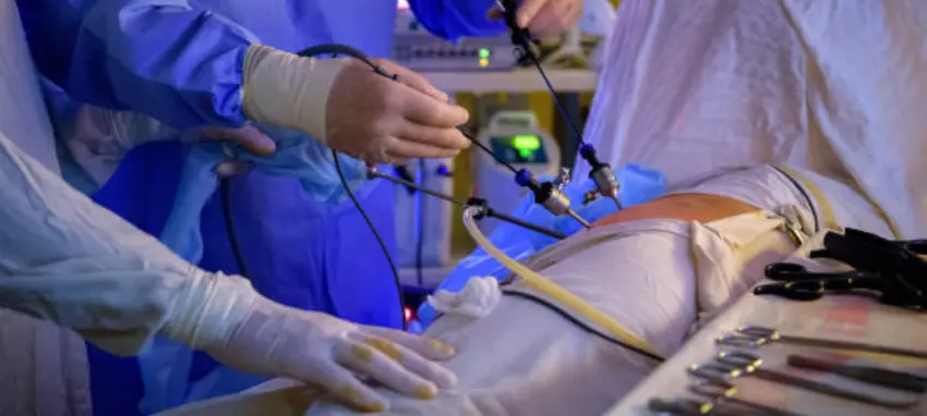 A surgeon carefully doing surgery on a patient lying on an operating table in neat hospital setting