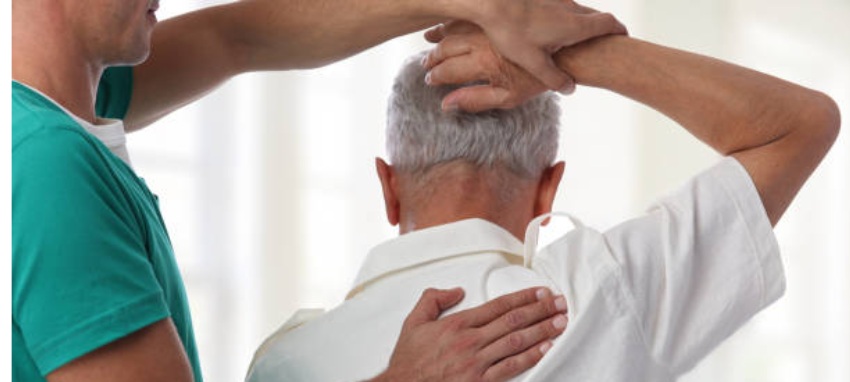 A doctor examines a man's Shoulder for any potential issues during a medical check-up.