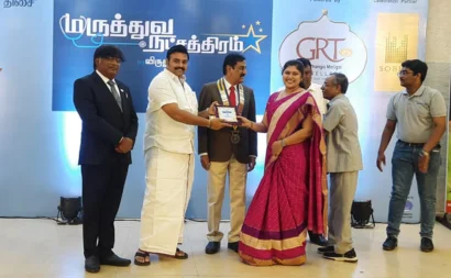 A man proudly giving an award to a woman at a formal event, celebrating their achievement.